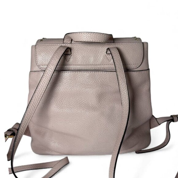 Michael Kors Riley small pebbled leather flap backpack in a light pink color